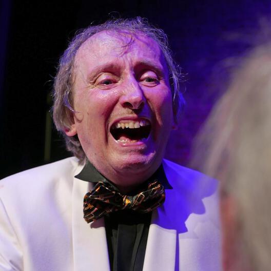 Nick laughing during a concert at Tring