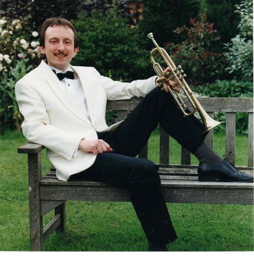 Nick reclining with a trumpet